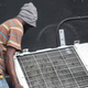 A man rips an air conditioner unit during a protest in Port-au-Prince, Haiti, Friday, Sept. 2019. (AP Photo/Edris Fortune)